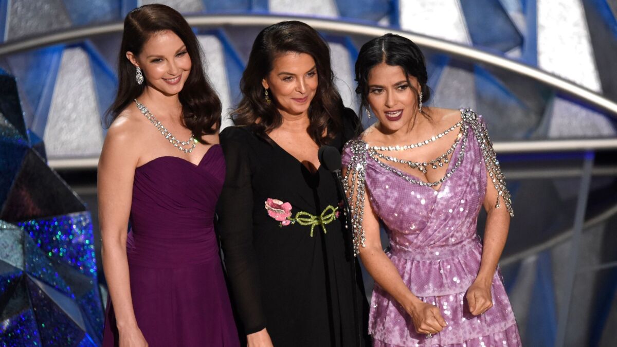 Ashley Judd, from left, Annabella Sciorra and Salma Hayek speak at the 90th Academy Awards.