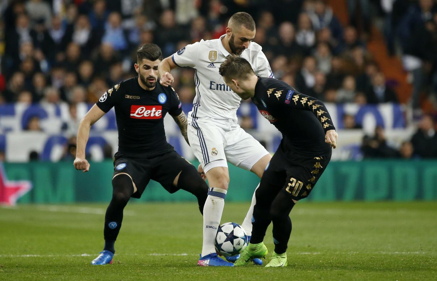 Real Madrid's Karim Benzema in action with Napoli's Piotr Zielinski