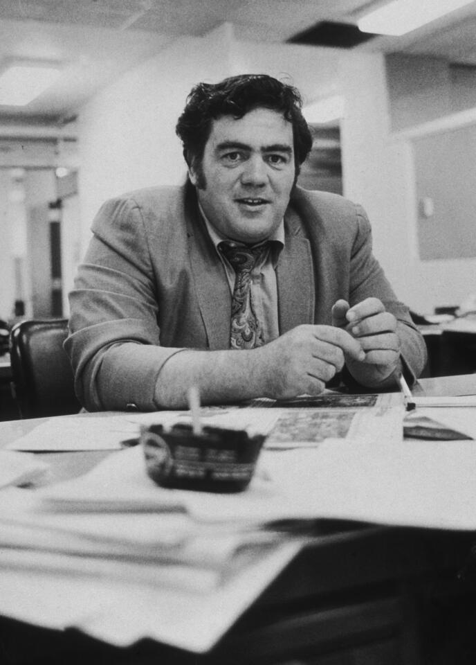 Jimmy Breslin, shown at his newspaper office desk in New York City in 1970, launched his career as a columnist at the New York Herald Tribune.