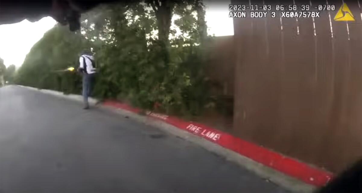 A screenshot from the video shows 48-year-old Douglas Quinn exchanging fire with the officers.