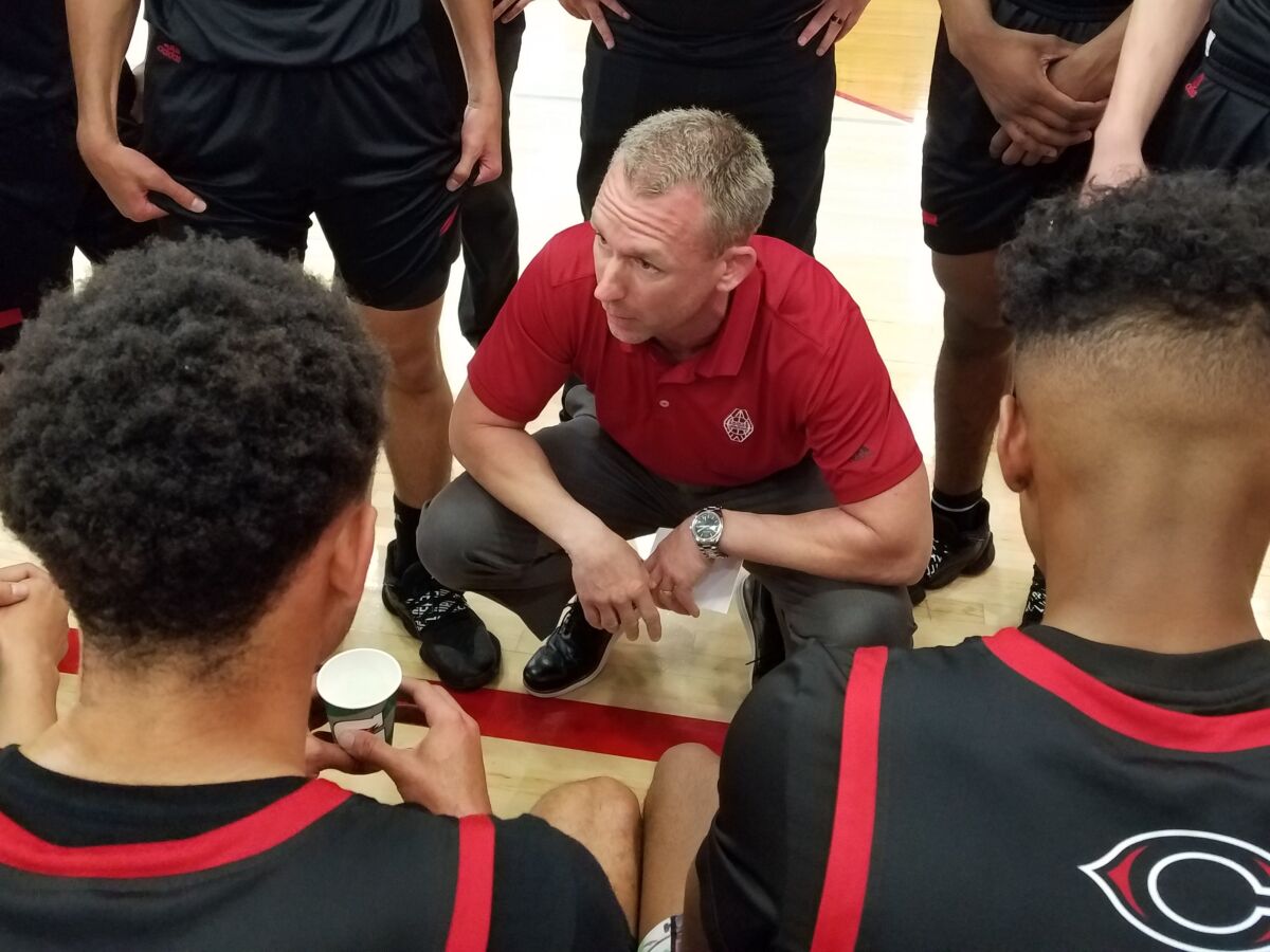Corona Centennial coach Josh Giles, shown talking strategy with his team, has guided the Huskies to a 25-2 record and No. 2 ranking in the Southland.