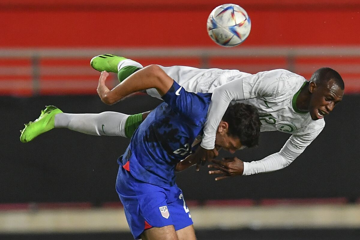 United States' Gio Reyna, bottom, duels for the ball with Saudi Arabia's Saud Abdullah Abdulhamid during the international friendly soccer match between Saudi Arabia and United States in Murcia, Spain, Tuesday, Sept. 27, 2022. (AP Photo/Jose Breton)