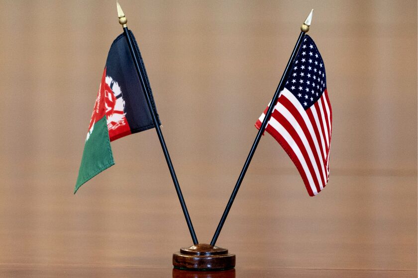 FILE - The flags of Afghanistan and the United States are seen on the table before a meeting at the Pentagon in Washington, June 25, 2021. The United States has taken control of Afghanistan's embassy in Washington and the country's consulates in New York and California. The State Department says it had assumed “sole responsibility” for the security and maintenance of the diplomatic missions effective on Monday and will bar anyone from entering them without its permission. The move came after the department said the embassy and consulates had “formally ceased conducting diplomatic and consular activities in the United States.” (AP Photo/Alex Brandon, File)
