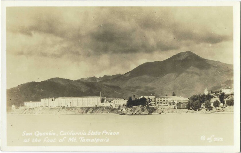 A sepia-tone image of San Quentin prison, with the San Francisco Bay in the foreground and Mt. Tamalpais in the background