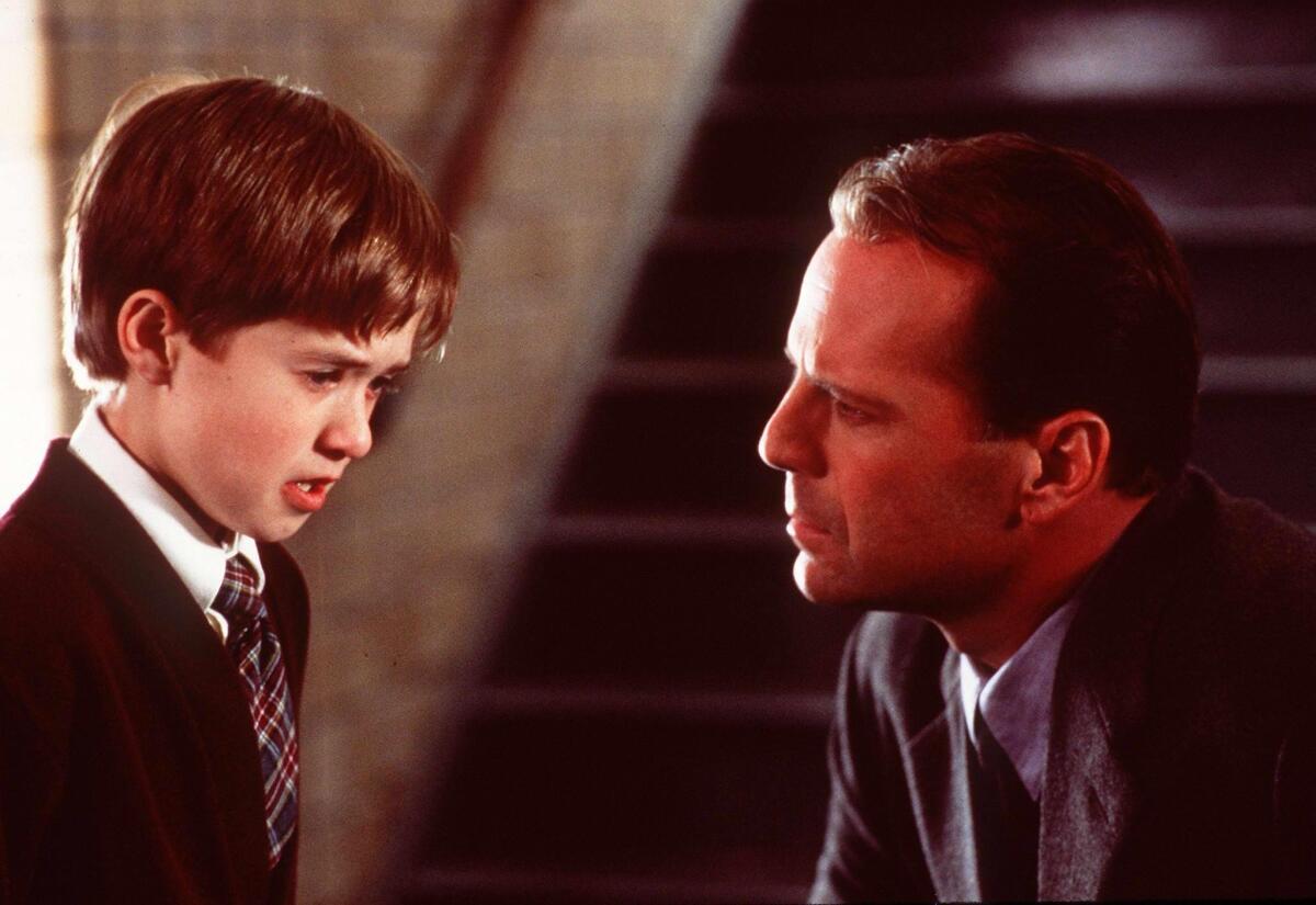 A boy and a man talk in a scene from "The Sixth Sense."
