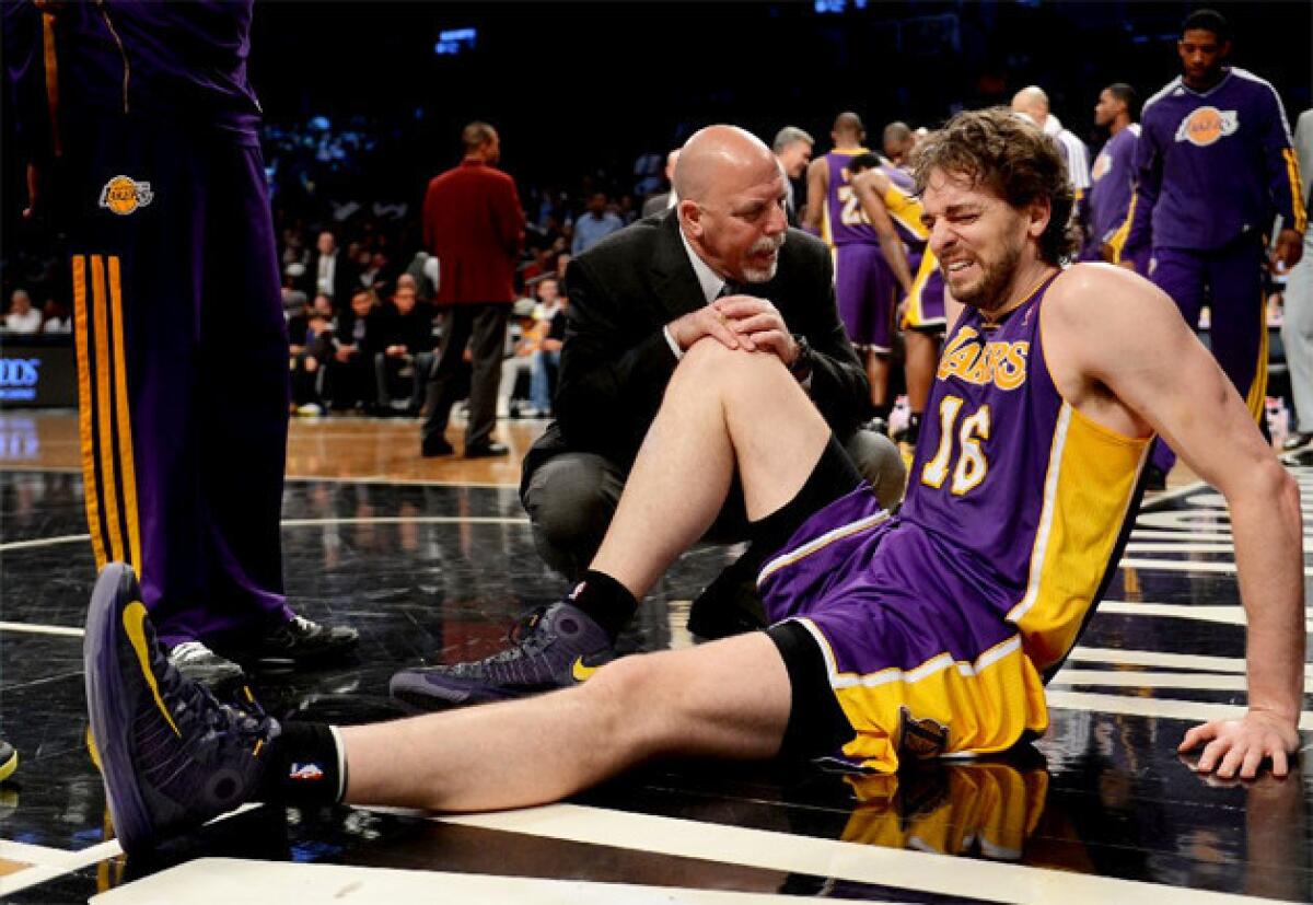 Lakers big man Pau Gasol grimaces after injuring himself against the Brooklyn Nets.