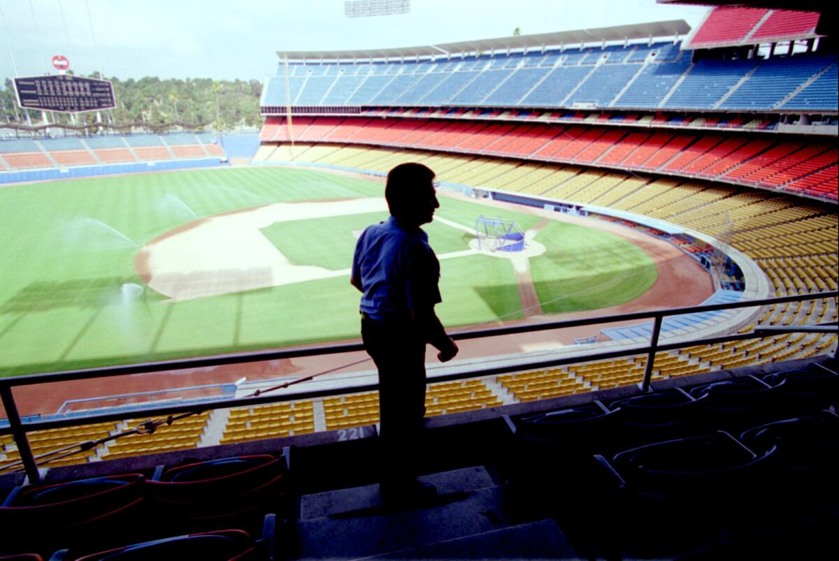 Security guard Oscar Garcia patrols an empty Dodger Stadium on Aug. 12, 1994, after the game between the Dodgers and Cubs was canceled because of the players' strike.