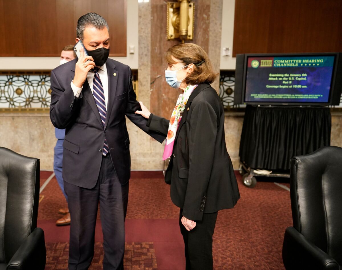Sen. Alex Padilla (D-Calif.) talks to Sen. Dianne Feinstein (D-Calif.) on Capitol Hill.