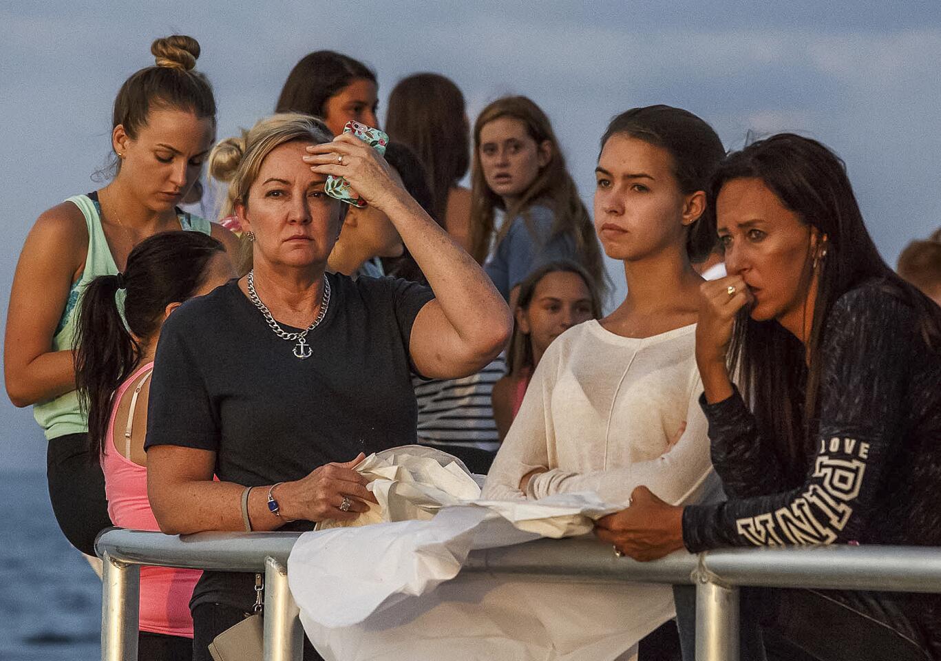 People gather during a candlelight vigil and paper balloon release for teenagers Austin Stephanos and Perry Cohen in Jupiter, Fla.