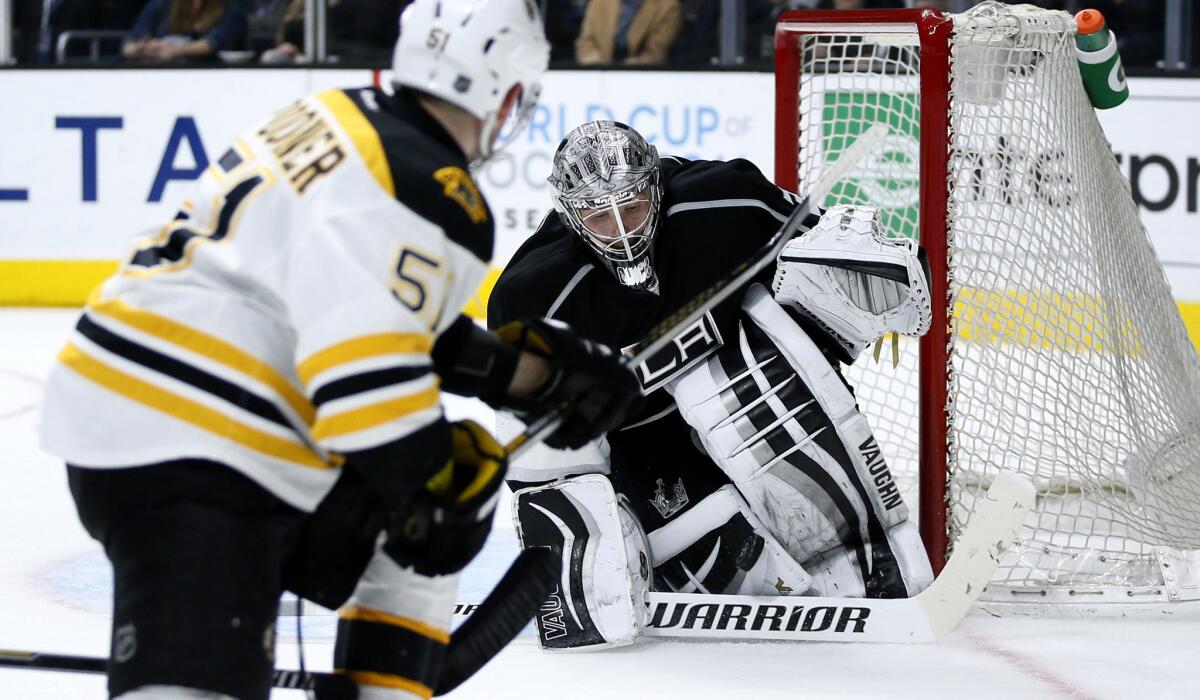 Kings goalie Jonathan Quick stops a shot by Bruins center Ryan Spooner during the third period Saturday.