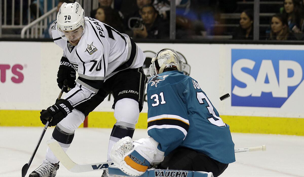 Kings' Tanner Pearson, left, shoots against San Jose Sharks goalie Martin Jones during the second period on Tuesday.