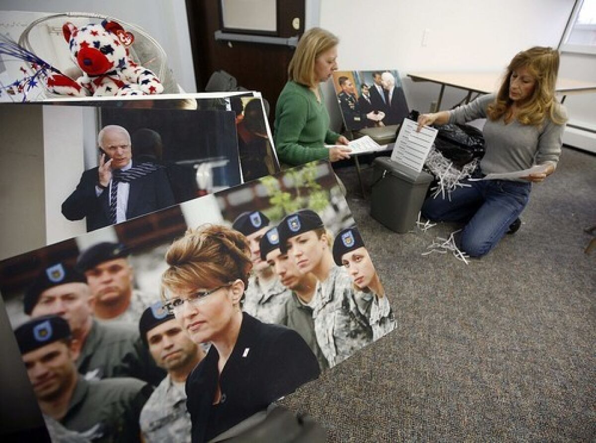 Workers pack up the McCain-Palin campaign headquarters in Anchorage. Aides to McCain on Wednesday disclosed new details about Palins expensive wardrobe purchases and other conflicts.