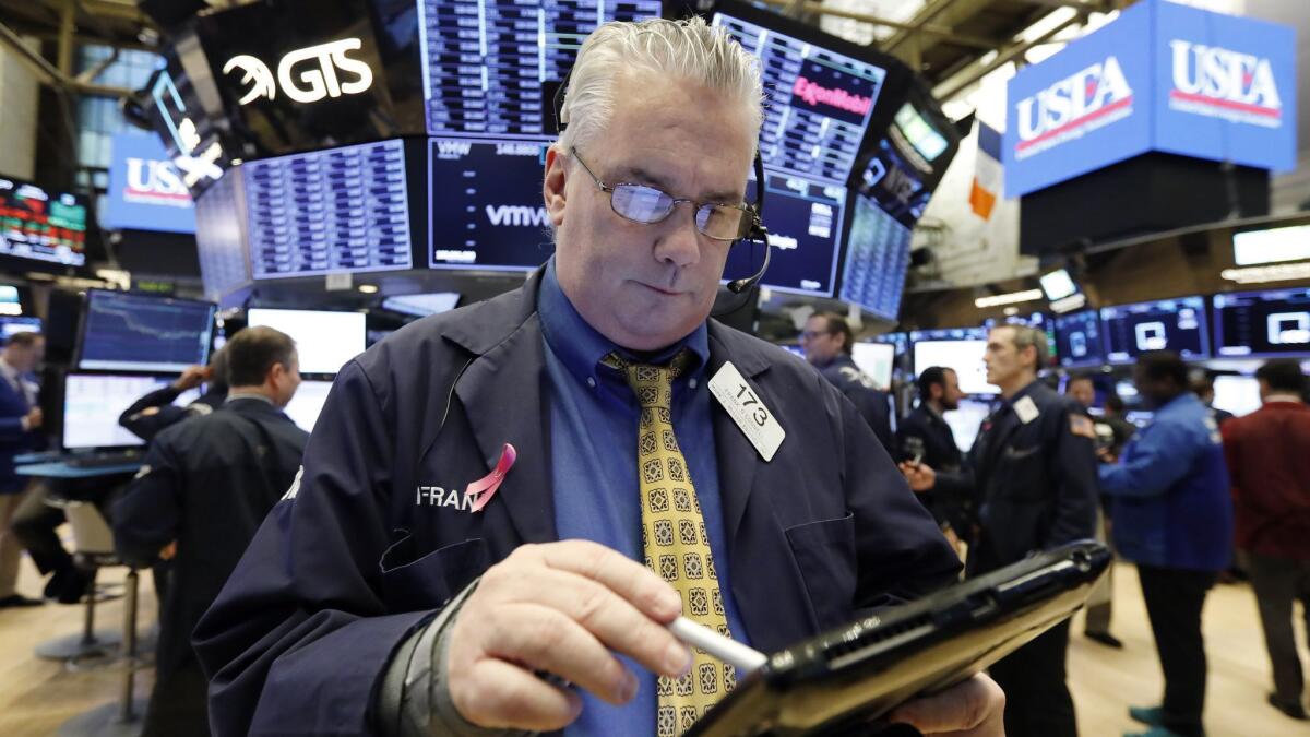 Trader Frank O'Connell works on the floor of the New York Stock Exchange on Friday.