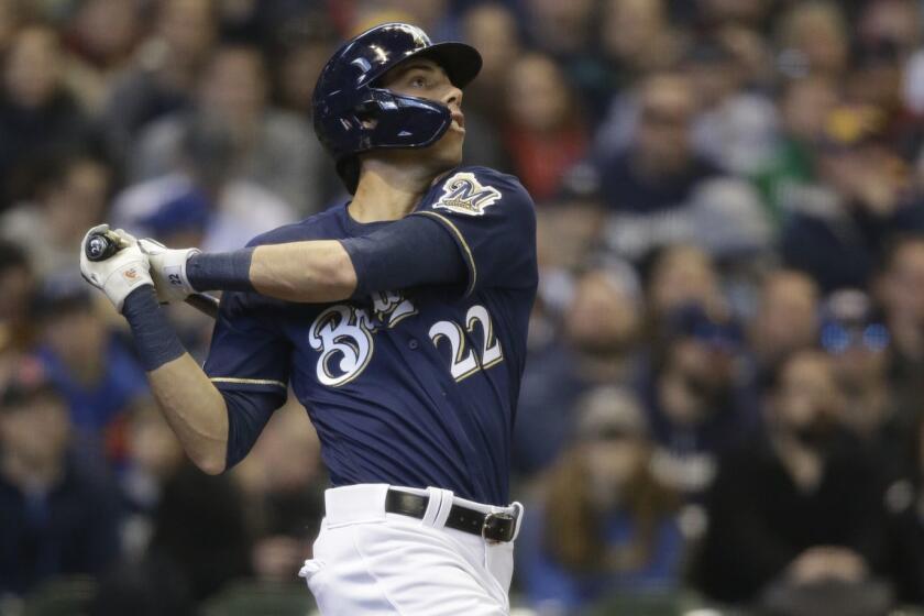 Milwaukee Brewers' Christian Yelich watches his home run against the St. Louis Cardinals during the first inning of a baseball game Sunday, March 31, 2019, in Milwaukee. (AP Photo/Jeffrey Phelps)