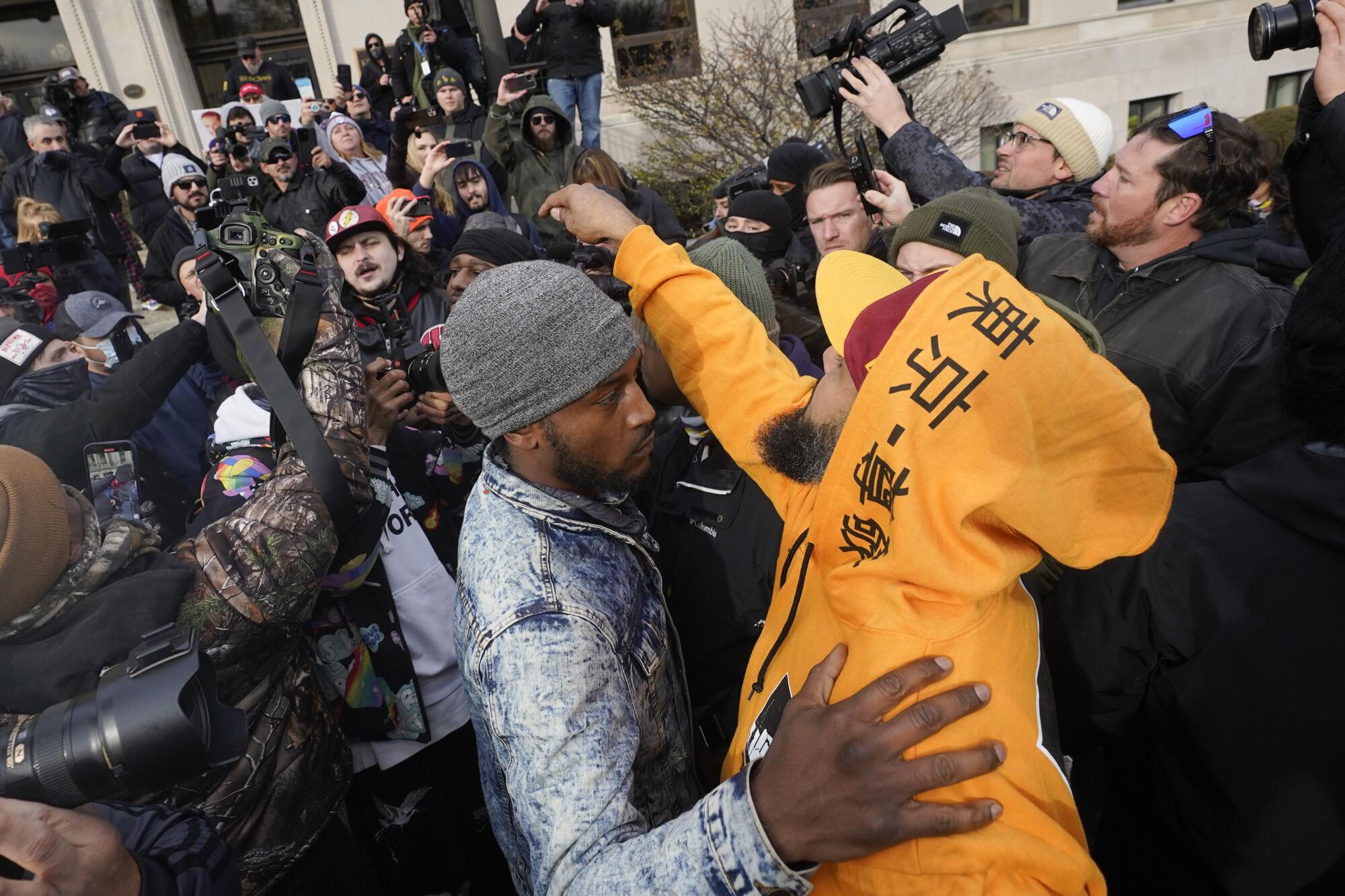 Protesters argue outside the Kenosha County Courthouse on Friday.