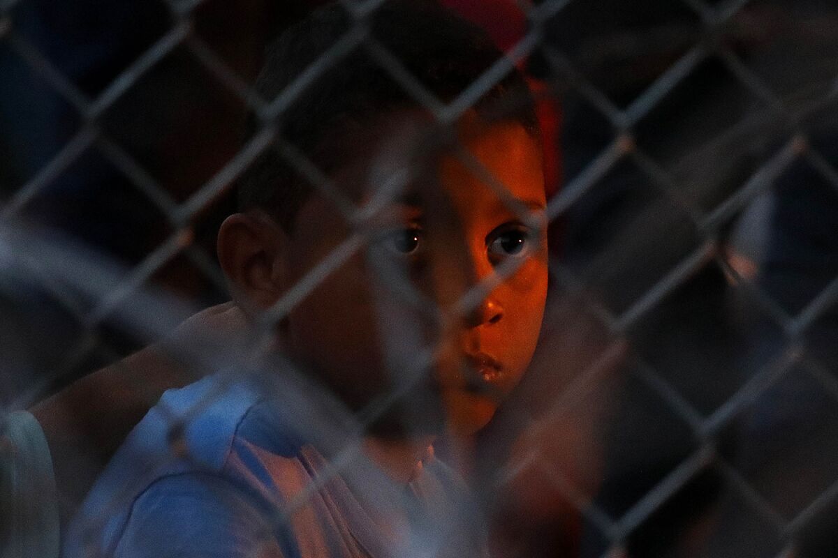 Right, a child waits at the shelter in Ciudad Juarez. (Gary Coronado / Los Angeles Times)