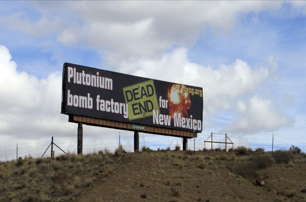 FILE - In this Feb. 17, 2021 photo, the Los Alamos Study Group takes aim at the U.S. government's plans to ramp up production of plutonium cores for the nation's nuclear arsenal with this billboard near Bernalillo, N.M. A watchdog group is suing the National Nuclear Security Administration over its failure to release public records related to the U.S. government's plans to manufacture key components for the nation's nuclear arsenal. The complaint filed Wednesday, April 6, 2022, in federal court covers more than a dozen records requests made since 2017 by the Los Alamos Study Group. (AP Photo/Susan Montoya Bryan,File)