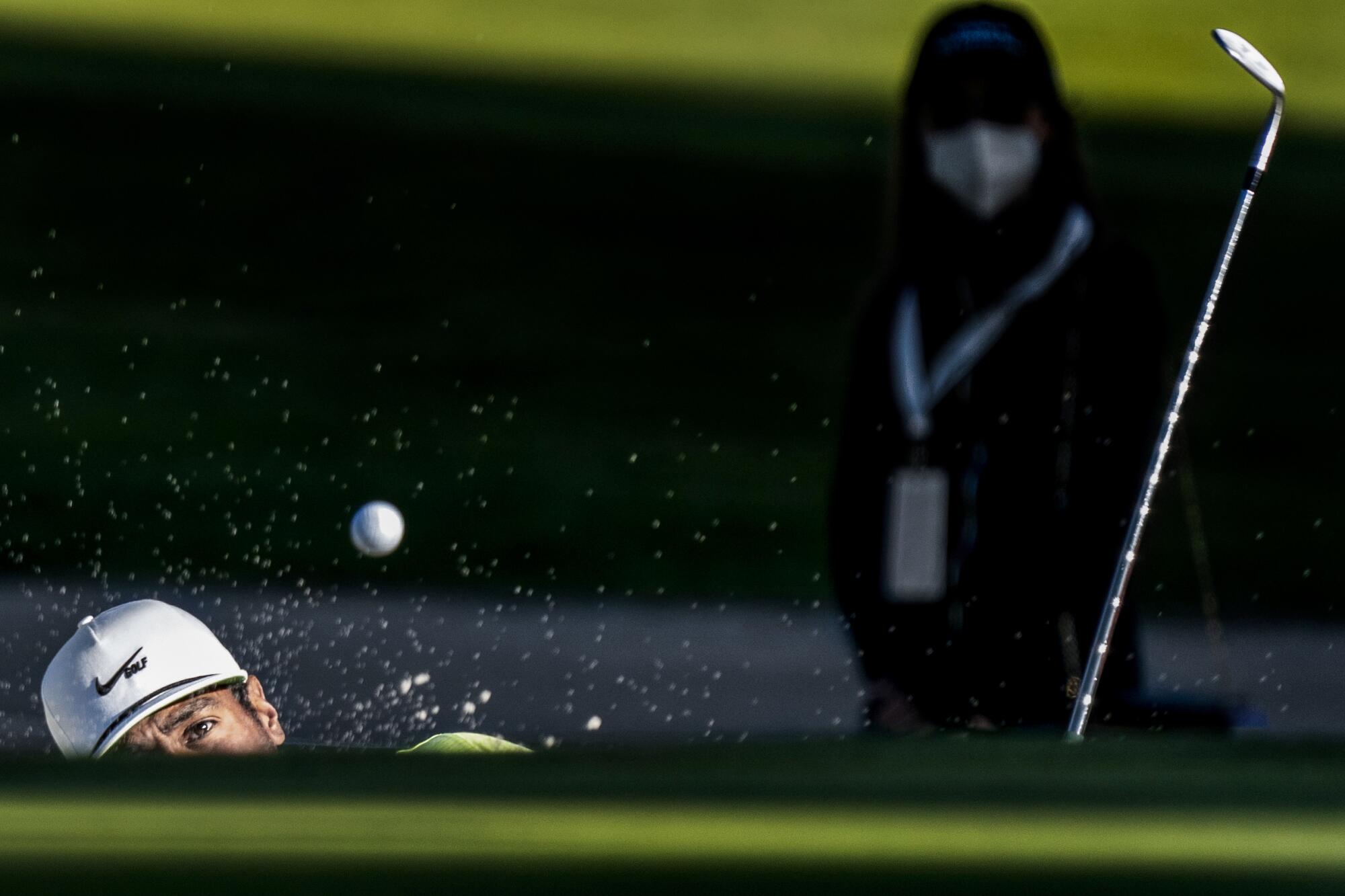 Tony Finau hits out of the green side bunker on the second playoff hole during the Genesis Invitational.