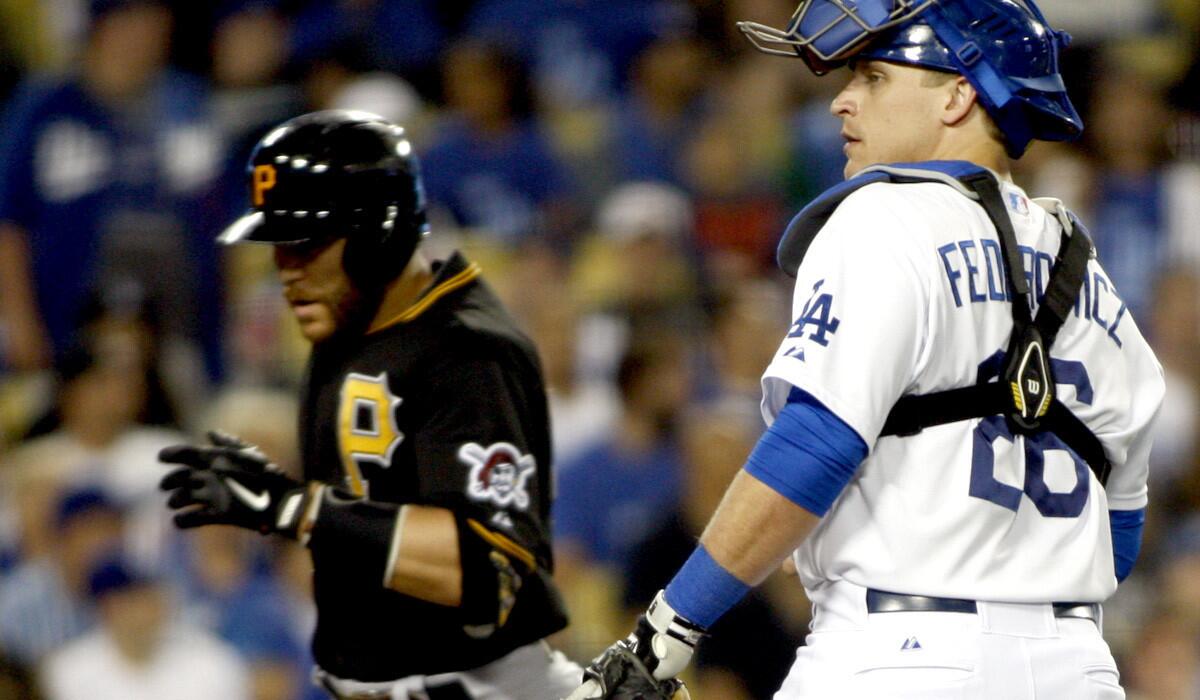 Dodgers catcher Tim Federowicz waits for Pittsburgh's Russell Martin to reach home plate after hitting a solo home run in the sixth inning Thursday night.