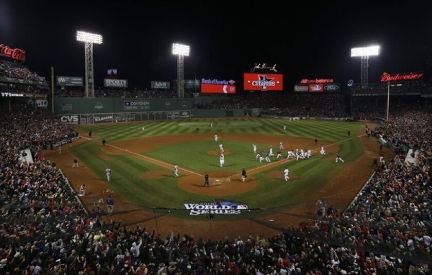 The Boston Red Sox run onto the field at Fenway Park after beating the St. Louis Cardinals in Game 6 of the World Series.