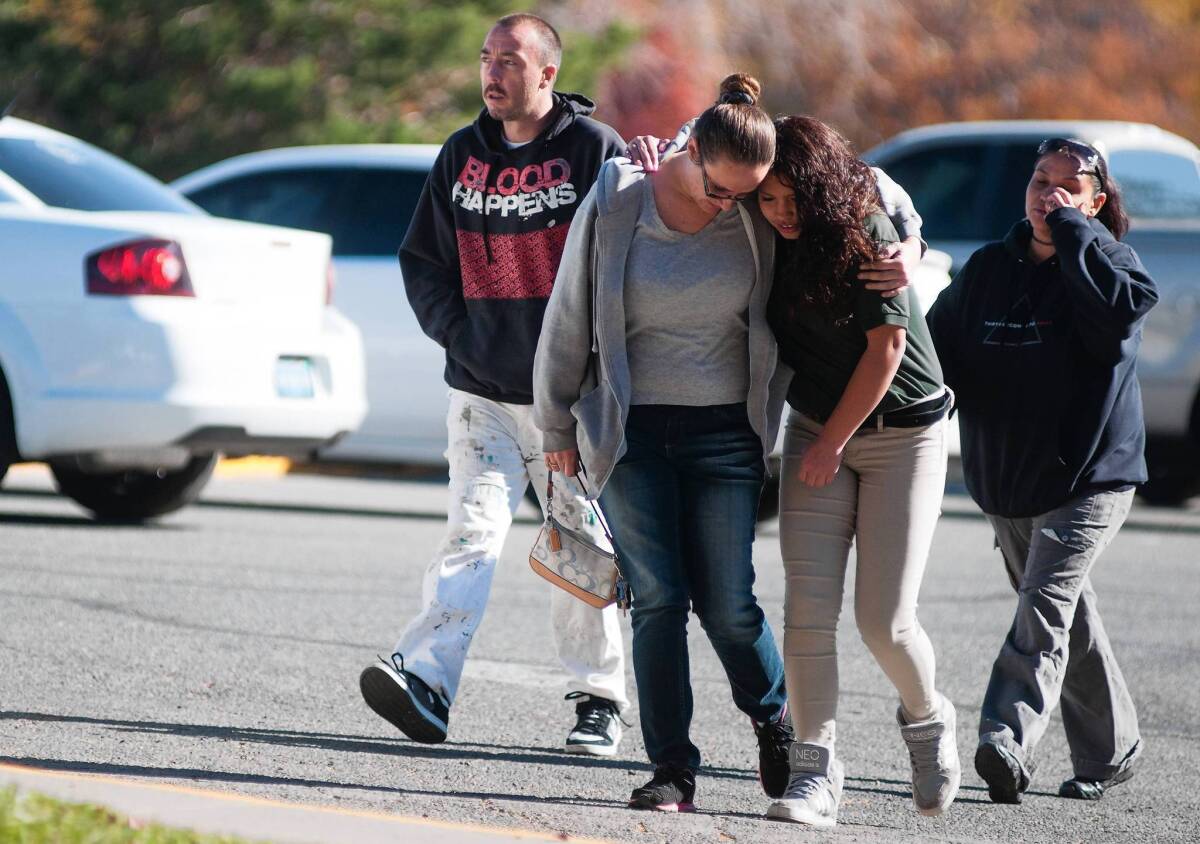 A Sparks Middle School student and her mother walk together after students were evacuated following a shooting that left two dead at the school.