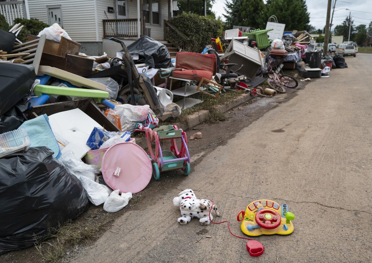 Debris from flood damage caused by the remnants of Hurricane Ida lie on the side of a street in Manville, N.J., Sunday, Sept. 5, 2021. Flood-stricken families and business owners across the Northeast are hauling waterlogged belongings to the curb and scraping away noxious mud as cleanup from Ida moves into high gear. (AP Photo/Craig Ruttle)