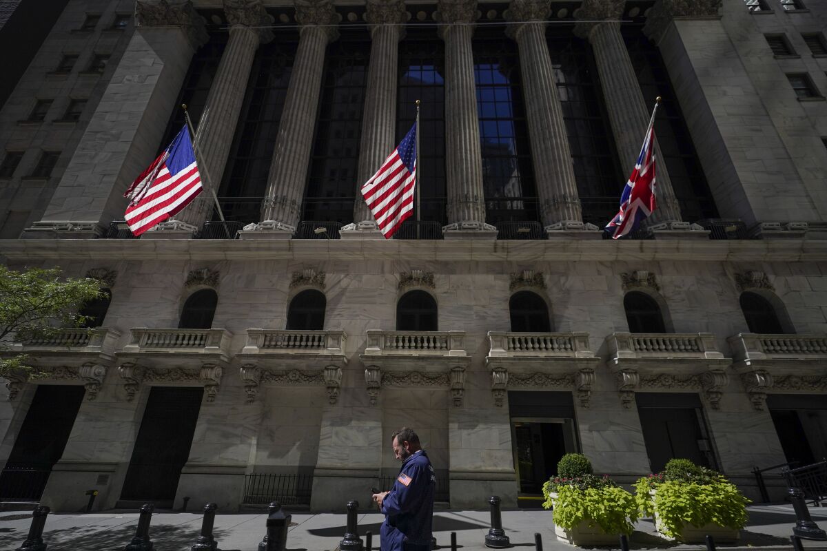 A pedestrian passes by the New York Stock Exchange.