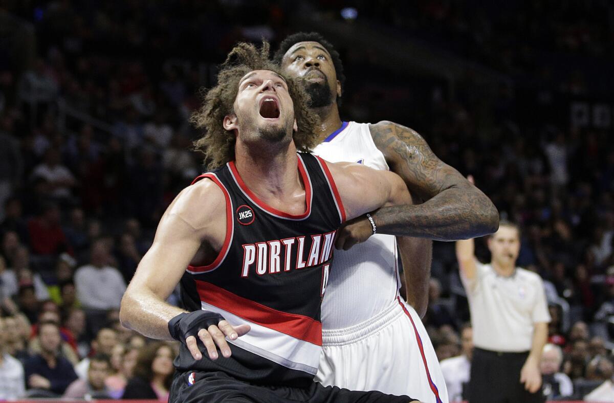 Trail Blazers center Robin Lopez and Clippers center DeAndre Jordan battle for position in the first half.
