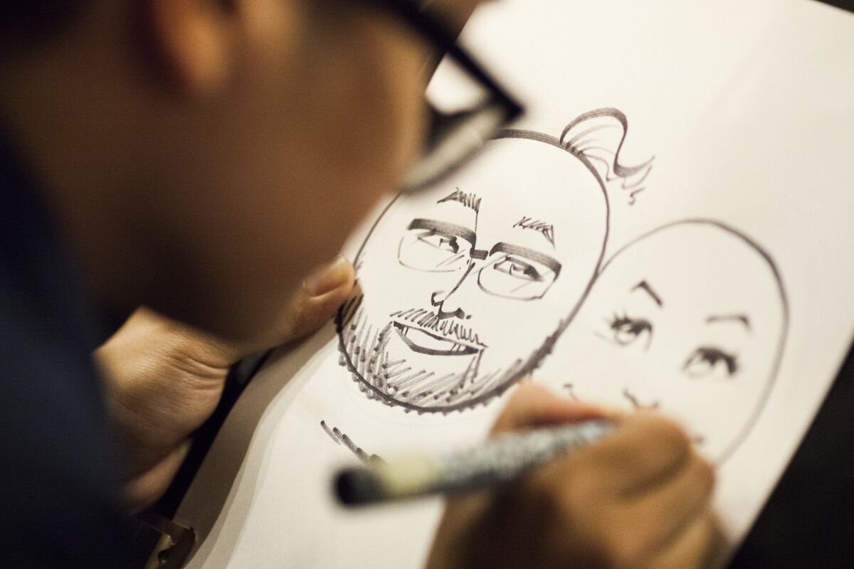 Caricature artist Ramon Sosongco Jr. draws emoji faces of attendees at the Emojicon launch party Friday, 4 Nov. 2016 at Covo a co-working space in San Francisco, CA, USA. (Peter DaSilva/For The Times)