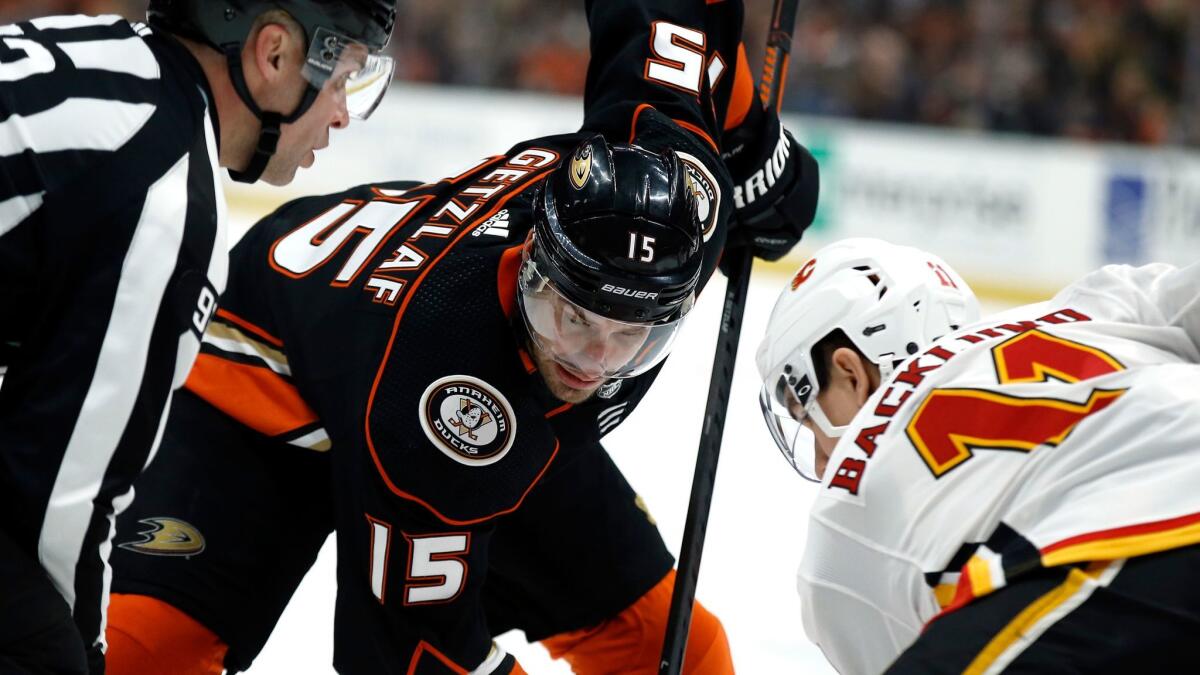 Anaheim Ducks center Ryan Getzlaf faces off against Calgary Flames center Mikael Backlund.