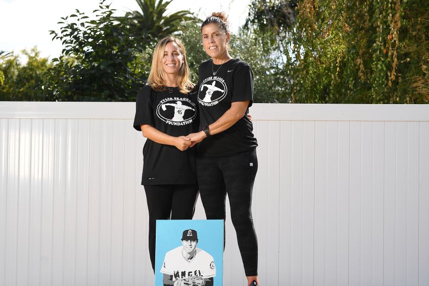 Tyler Skaggs wife, Carli Skaggs and his mother Debbie stand on a pitchers mound in the backyard of the home he grew up in.