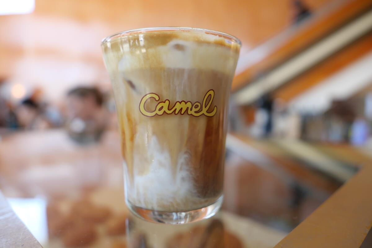 A signature cream top coffee in a glass at Camel Coffee in Los Angeles.
