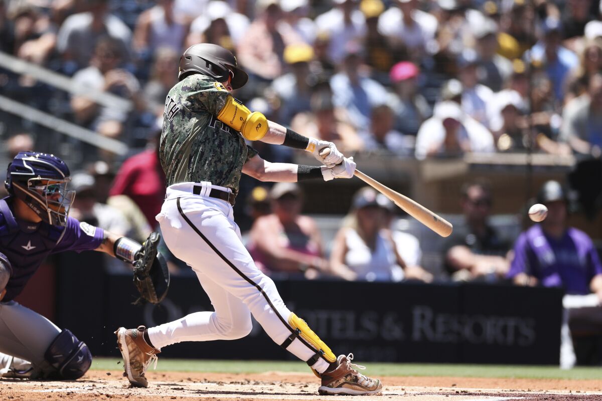 San Diego Padres' Jake Cronenworth hits an RBI-double against the Colorado Rockies in the first inning of a baseball game Sunday, Aug. 1, 2021, in San Diego. (AP Photo/Derrick Tuskan)