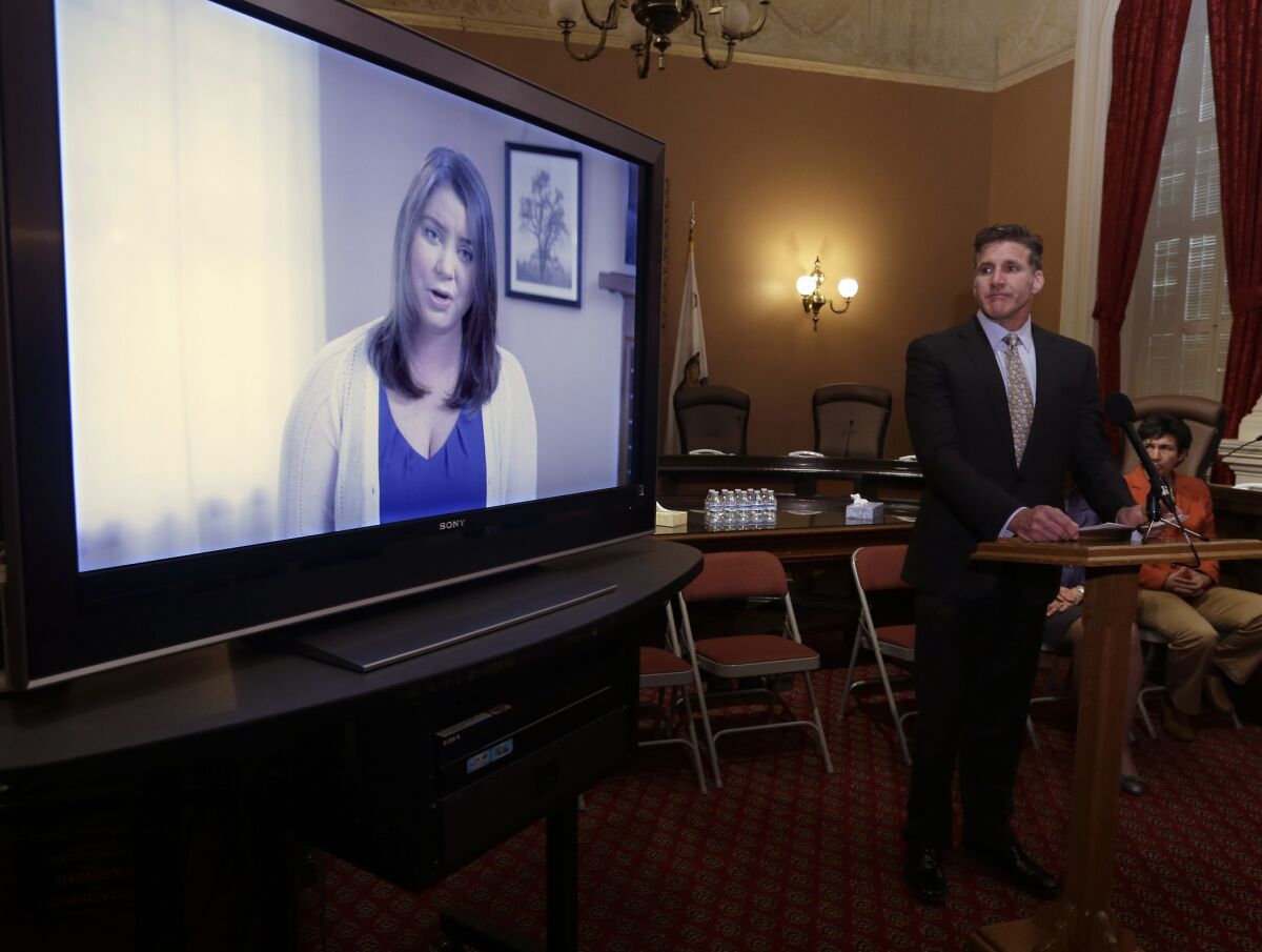 Dan Diaz, the husband of Brittany Maynard, watches a video of his wife, recorded 19 days before her assisted-suicide death in Oregon last year, at the Capitol in Sacramento on March 25.