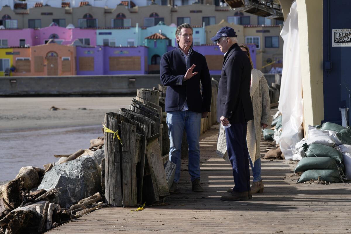 President Biden talks with  Gov. Gavin Newsom on a boardwalk