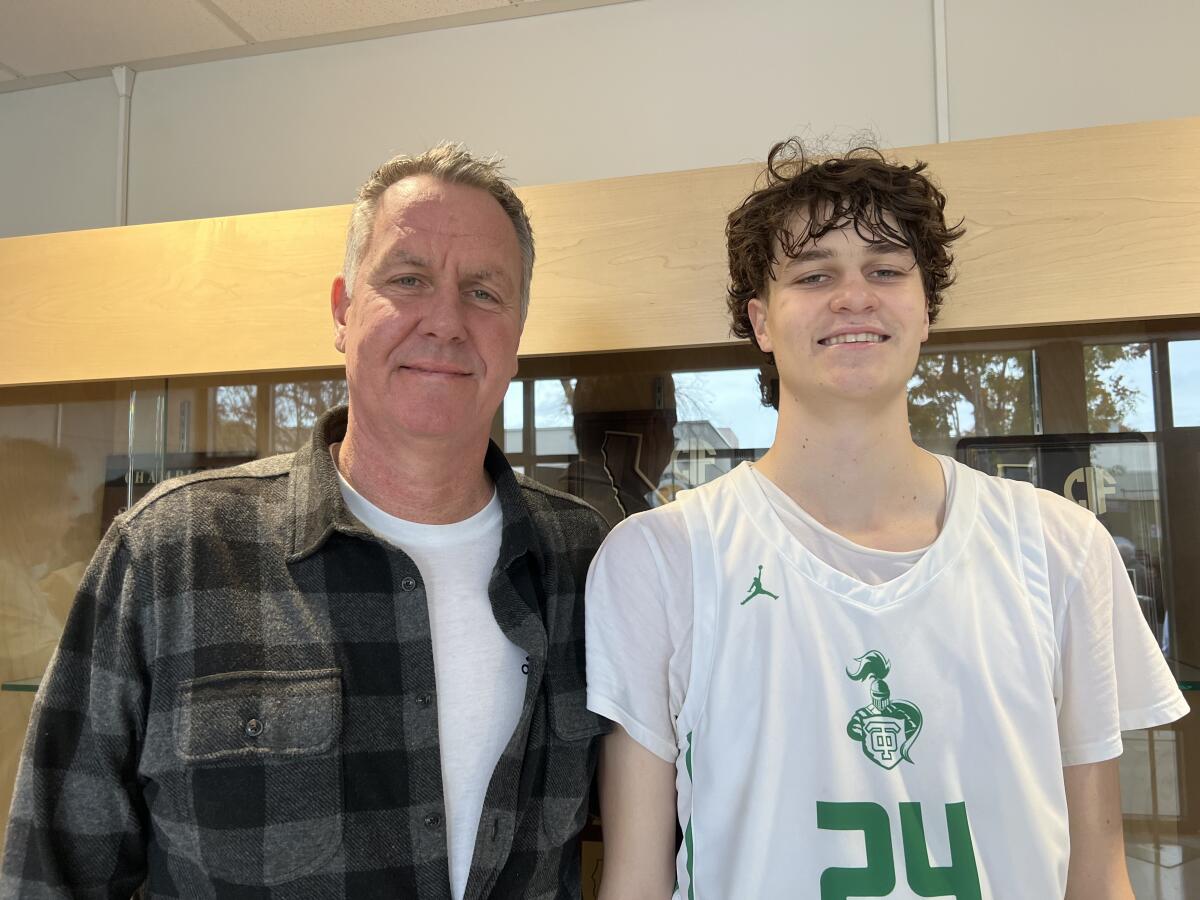 Don MacLean, UCLA's all-time scoring leader, stands next to his son, 6-9 sophomore Trent MacLean of Thousand Oaks.