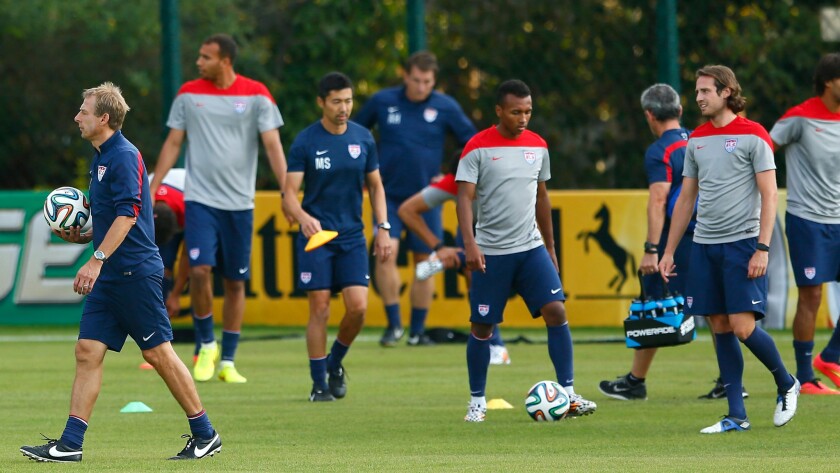 U.S. Coach Jurgen Klinsmann, left, looks on during a team training session in Sao Paulo, Brazil on Monday. The U.S. will play Germany on Thursday.