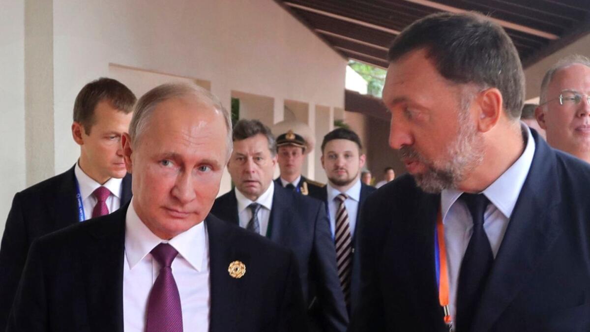 Russian President Vladimir Putin, left, in 2017 file photograph with metals magnate Oleg Deripaska, who is among seven Russian billionaires sanctioned by the U.S. government.