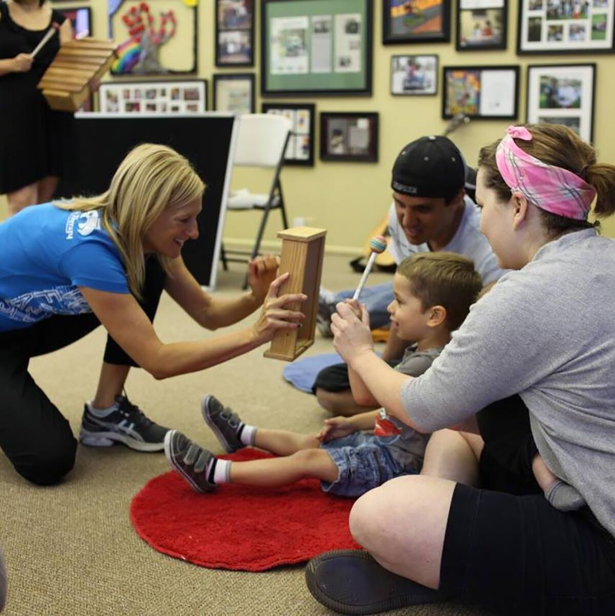 Therapist Julie Guy (left) works with a family at a musical playgroup hosted by the Autism Tree Project Foundation.