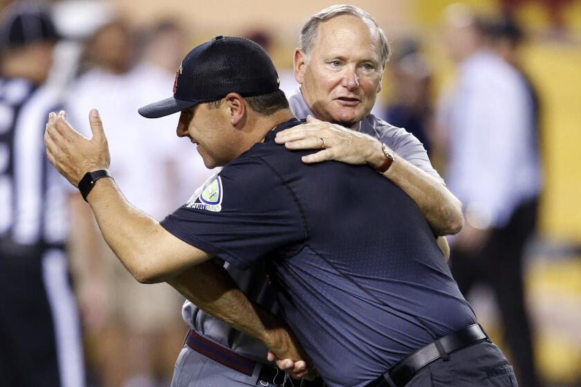 USC football coach Steve Sarkisian receives a hug from athletic director Pat Haden prior to the team's game against Arizona State in Tempe, Ariz. Sept. 26.