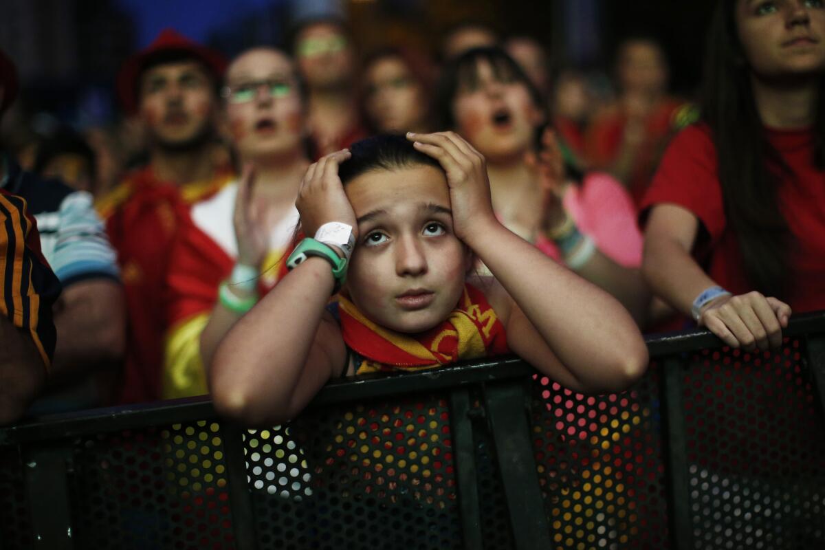 A Spanish soccer fan watches the World Cup match between Spain and Chile on a giant display in Madrid.