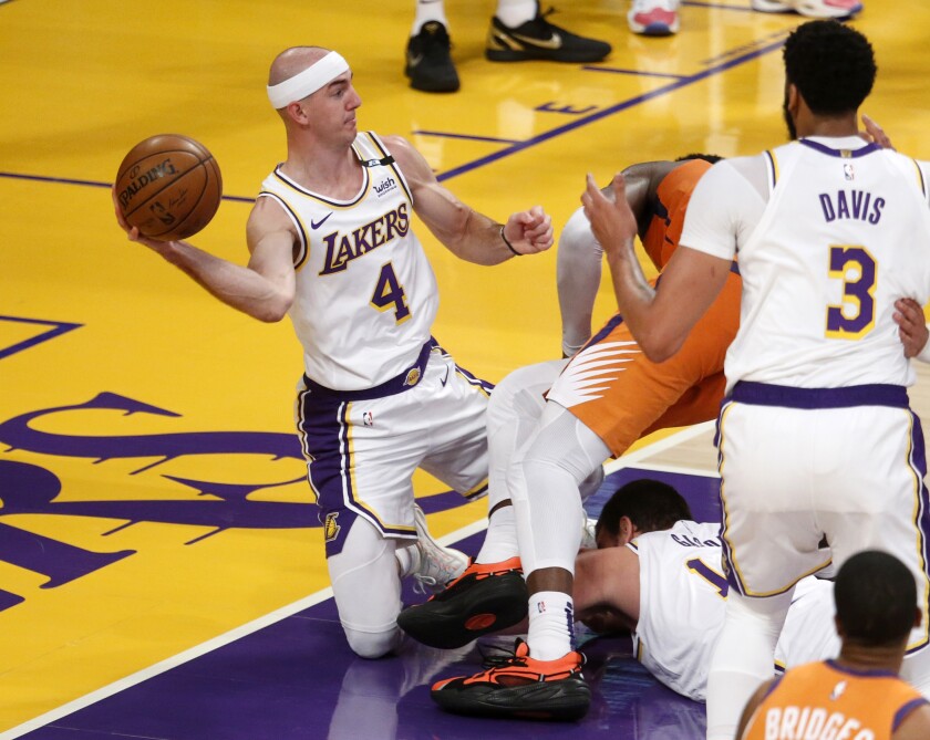 Lakers guard Alex Caruso looks to save a loose ball during a game against Phoenix.