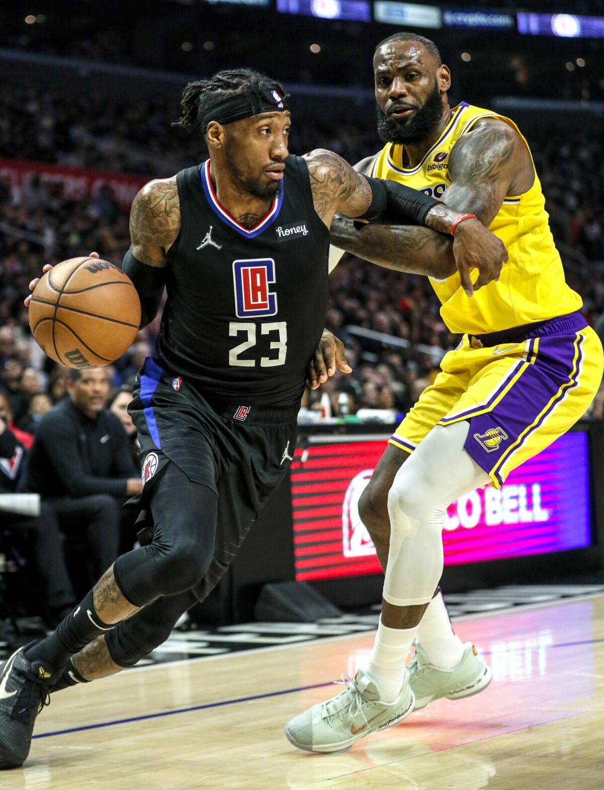 Clippers forward Robert Covington drives against Lakers forward LeBron James.