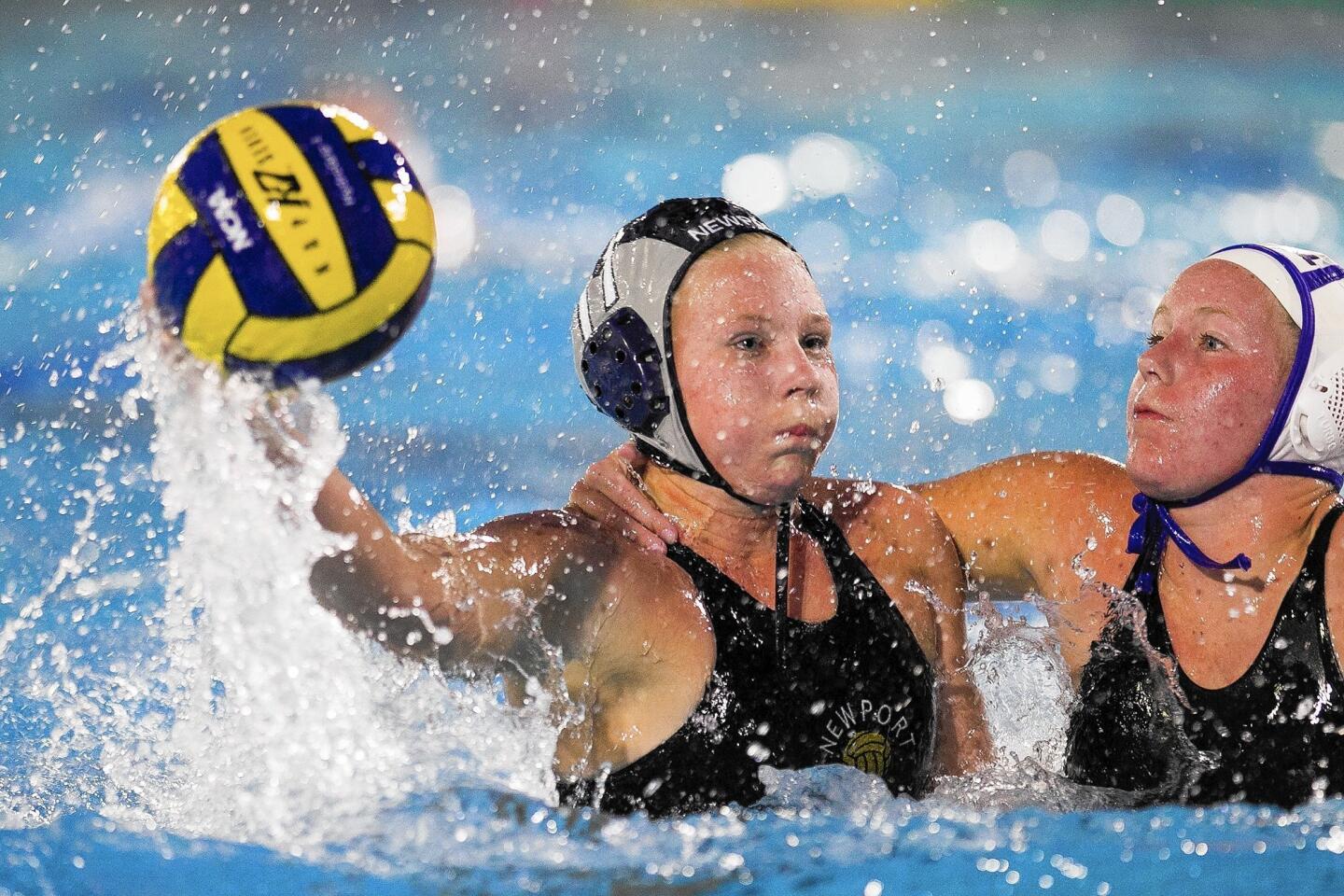 Los Alamitos' Abbey Blake wraps up Newport Harbor's Lissa Westerman as she takes a shot during a Sunset League game on Thursday.
