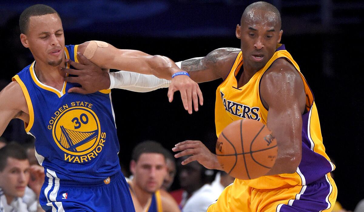 Lakers guard Kobe Bryant battles Warriors point guard Stephen Curry for a loose ball during their exhibition game Thursday night at Staples Center.