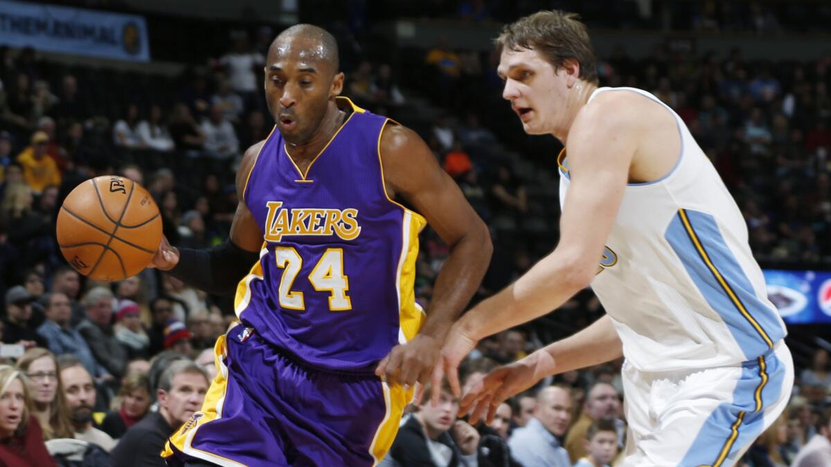 Lakers guard Kobe Bryant, left, drives past Denver Nuggets center Timofey Mozgov during the first half of the Lakers' 111-103 win on Dec. 30.