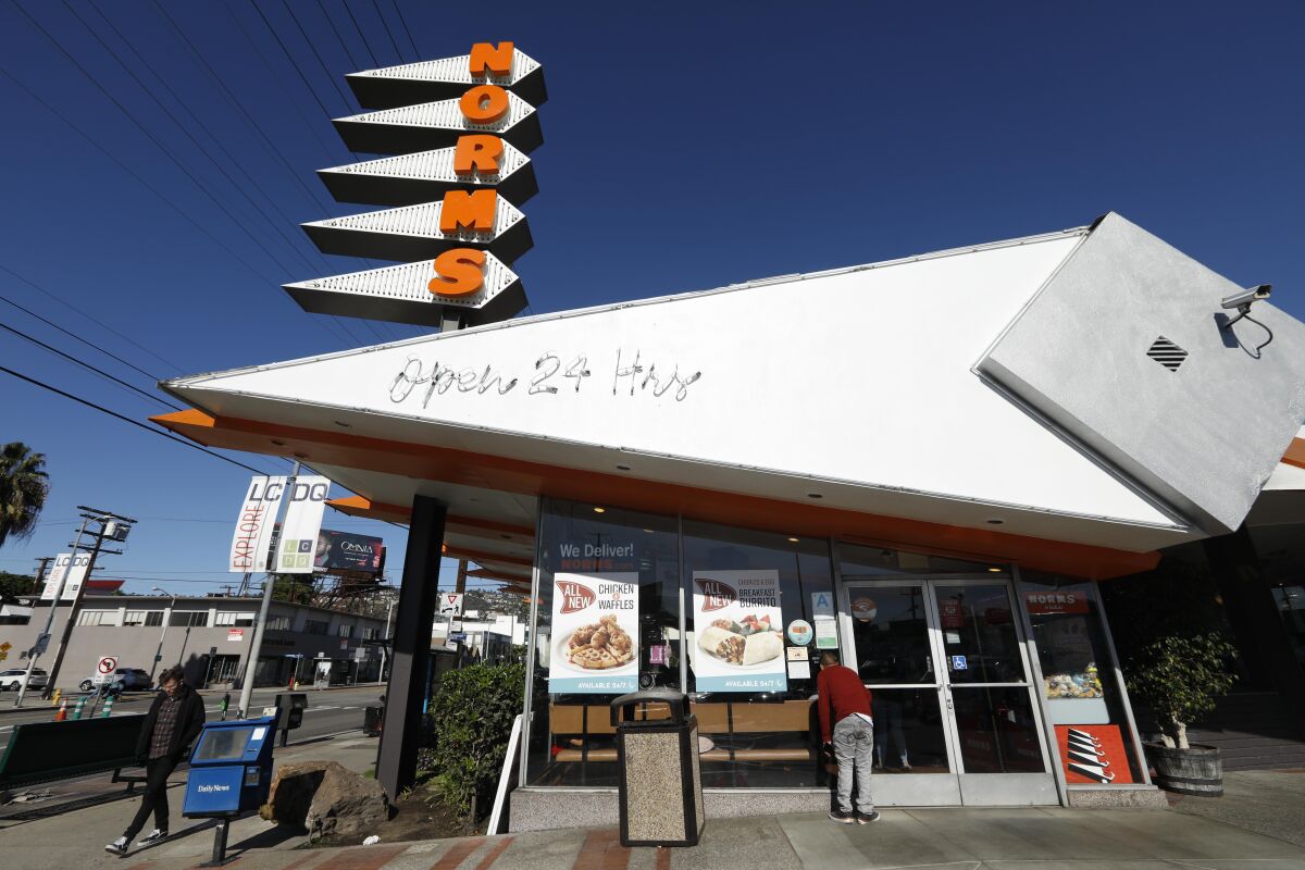 A customer looks into the window of Norms Restaurant on La Cienega Boulevard in West Hollywood