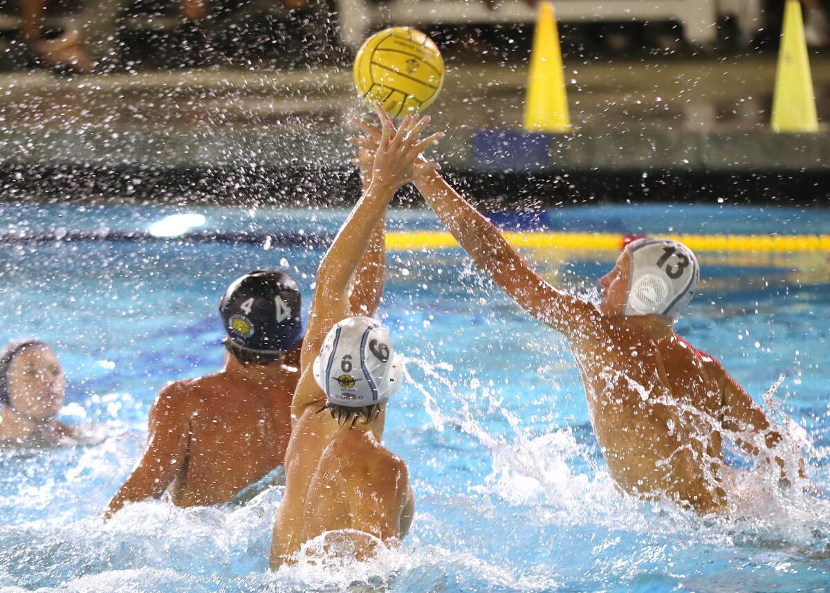 Newport Harbor's Peter Castillo (4) has his pass tipped away by CdM's Noah Gerard (13) during the Battle of the Bay game.