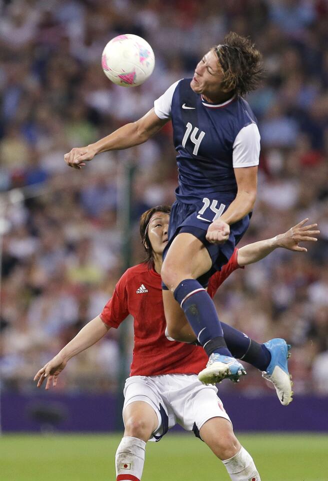 U.S. forward Abby Wambach is uncontested as she leaps skyward for a header during the women's soccer final against Japan.