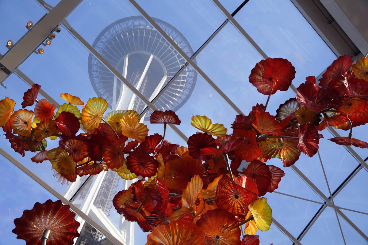 The Space Needle towers over the Chihuly Garden and Glass museum in the Seattle Center.